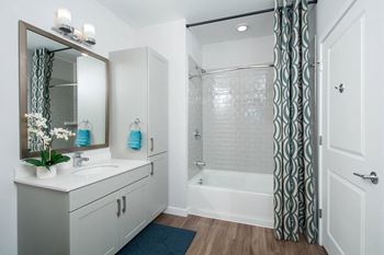 Luxurious tile surrounds in bathrooms with curved shower rods